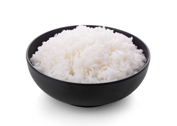 istock Rice in a black bowl isolated on a white background 1215861164