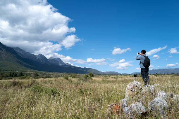 istock A young man taking photos outdoors using his mobile phone 1215861185