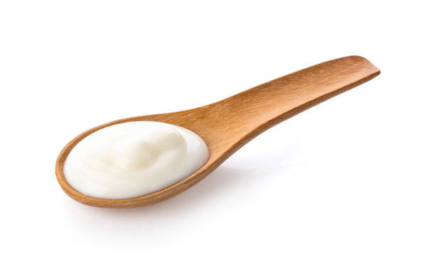 istock yogurt in wood spoon  isolated on white background from top view 1215861220