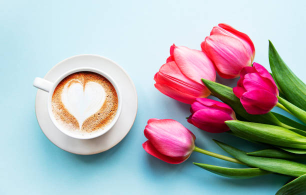 istock Coffee cup with latte art and tulips 1215862074