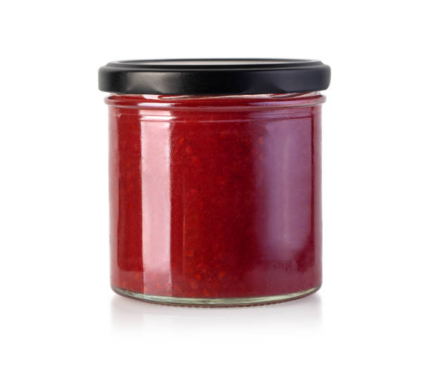 istock Apricot jam glass jar isolated on white 1215863464