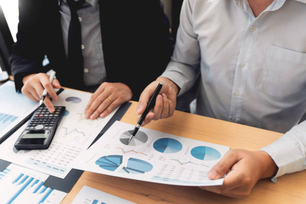 istock Business Corporate team brainstorming, Planning Strategy having a discussion Analysis investment researching with chart at office his desk documents and saving concept. 1215863649