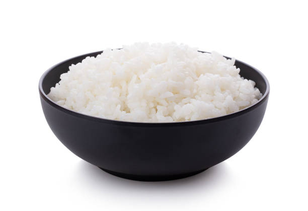 istock Rice in a black bowl isolated on a white background 1215864973