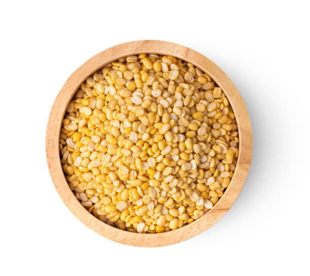 istock peeled split mung beans in wood bowl isolated on white background. top view 1215865267