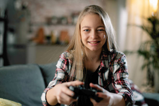 istock Little girl playing video game 1215866357