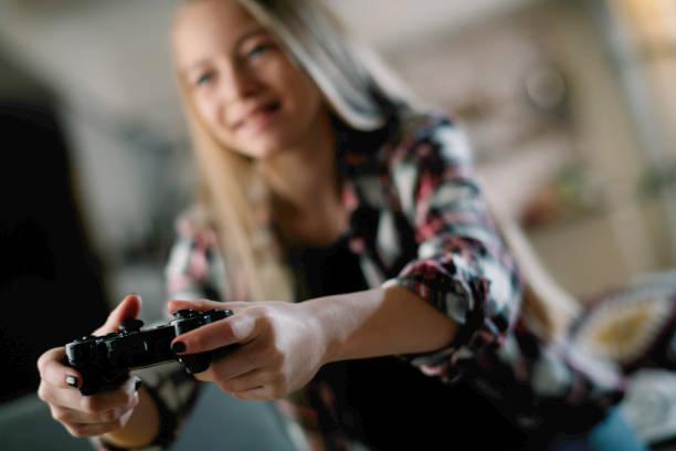 istock Little girl playing video game 1215866481