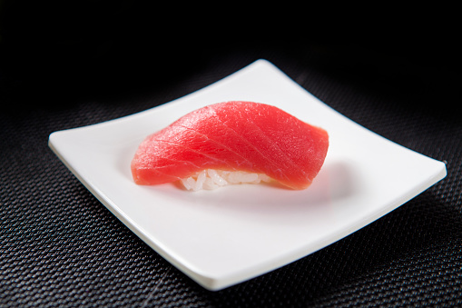 Sushi closeup isolated on white background. Sushi with algae nori rice salmon and chuka.