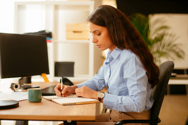 istock Businesswoman drining coffee and working. 1215866597