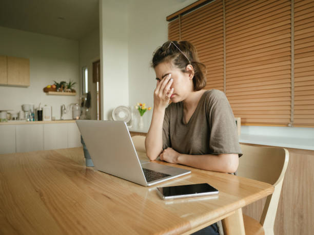 istock Depressed female executive sitting at desk 1215867212