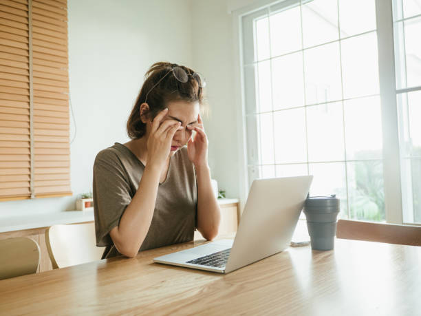 istock Asian woman struggling with using laptop at home. 1215867233