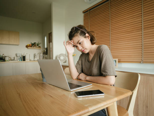 istock Depressed female executive sitting at desk 1215867305