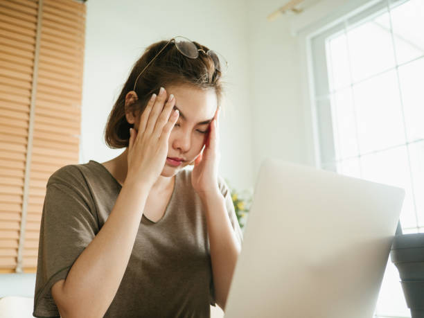 istock Depressed female executive sitting at desk 1215867357