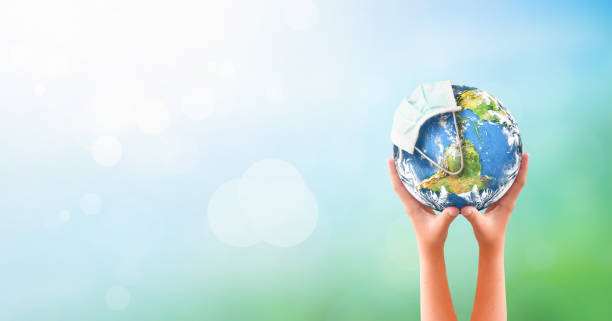 istock Earth Day concept: Corona virus or COVID-19 Earth wearing a mask 1215867366