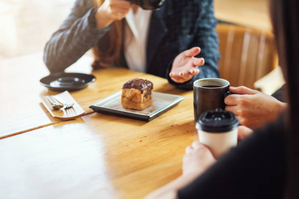 istock people enjoyed talking and drinking coffee together in cafe 1215867773