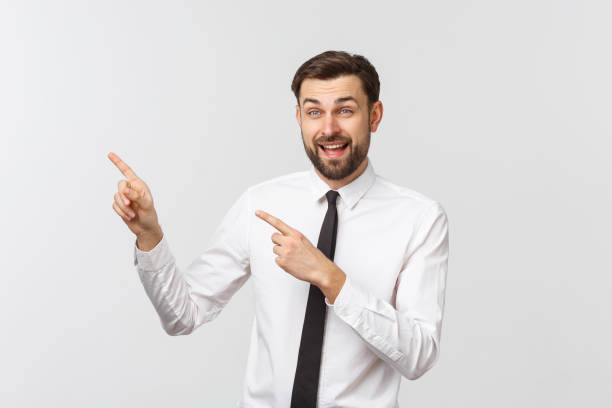 istock Young handsome businessman pointing to something using a finger. Isolated on white 1215870233