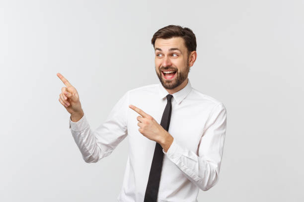 istock Young handsome businessman pointing to something using a finger. Isolated on white 1215870269