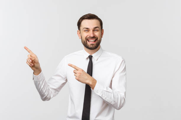 istock Young handsome businessman pointing to something using a finger. Isolated on white 1215870286