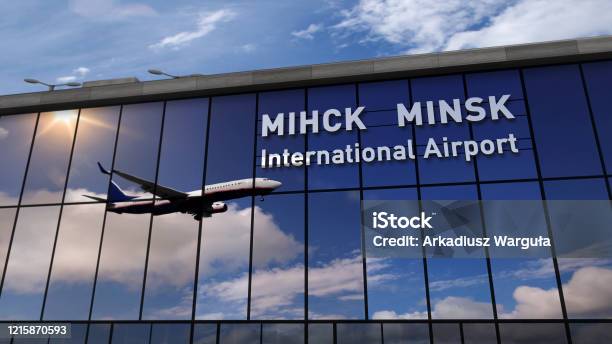Airplane Landing At Minsk Mirrored In Terminal Stock Photo - Download Image Now - Minsk, Airport, Belarus