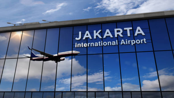 istock Airplane landing at Jakarta mirrored in terminal 1215870618