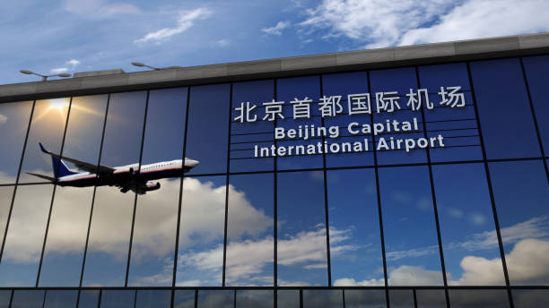 istock Airplane landing at Beijing PEK mirrored in terminal 1215871446