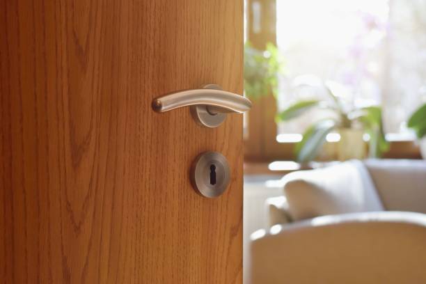 istock Half opened door into the cozy home interior 1215872699
