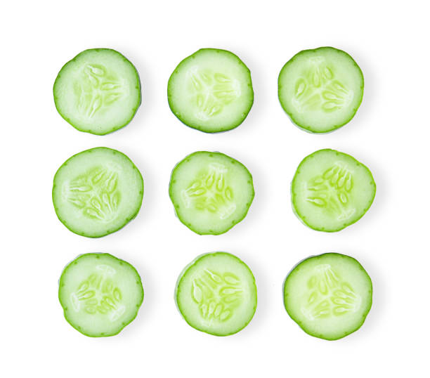 istock Fresh cucumber slices, isolated on white background. top view 1215874002