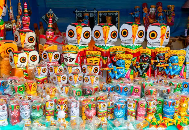 Photo of A collection of colorful traditional wooden owl sculpture and toys.
