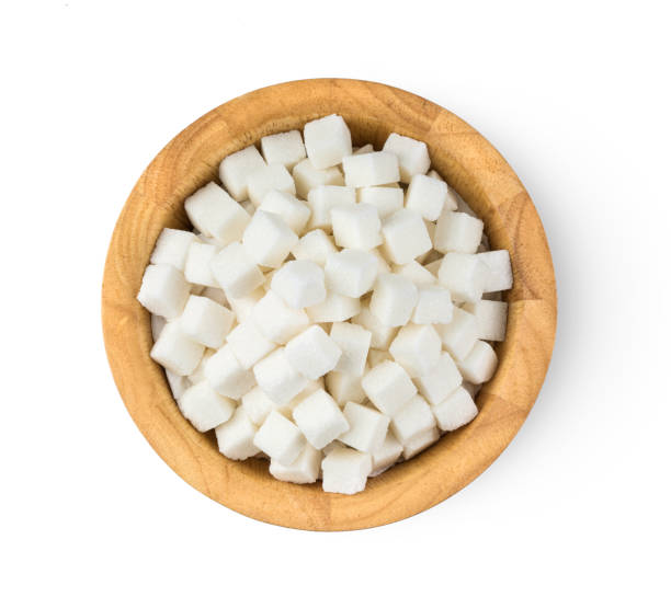 istock Sugar cube in wood bowl isolated on white background. top view 1215874626