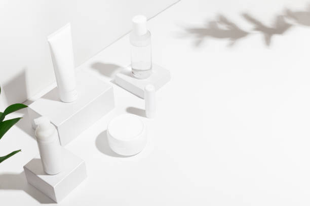 istock White blank mockup bottle cream container lipstick and spray standing on shipping boxes. Copy space in right side. Professional tubes for facial and body treatment. Skincare and wellness concept 1215875946