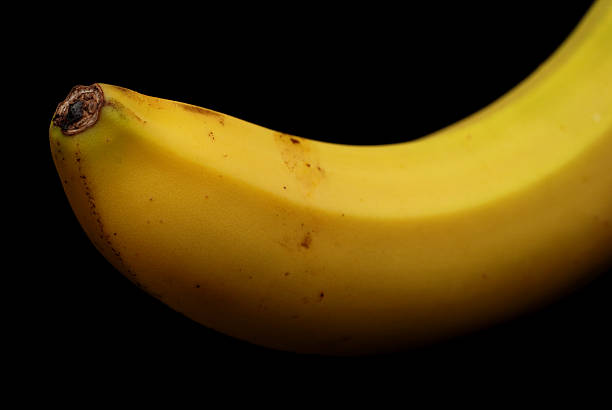 istock Isolated bio banana illuminated from above on black 121587768