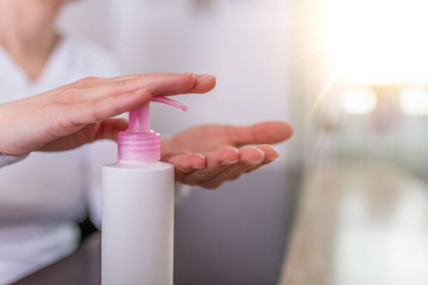 istock Woman wearing protective mask,using alcohol antiseptic gel,prevent infection,outbreak of Covid-19, woman washing hand with hand sanitizer to avoid contaminating with Coronavirus 1215877848