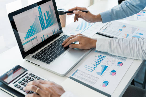 istock Business People Talking Discussing with coworker planning analyzing financial document data charts and graphs in Meeting and  successful teamwork Concept 1215881269