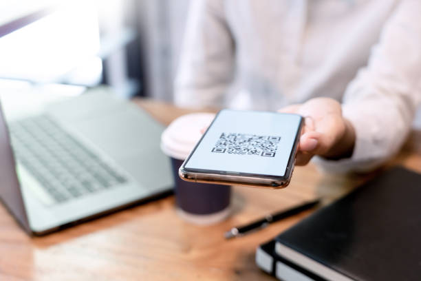 istock Man's hand holding smartphone with QR code on the screen, payment, E wallet , cashless technology generate digital pay without money. concept 1215881270