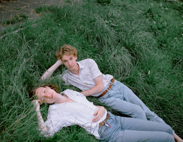 istock Cute couple lying down in grass 1215881305
