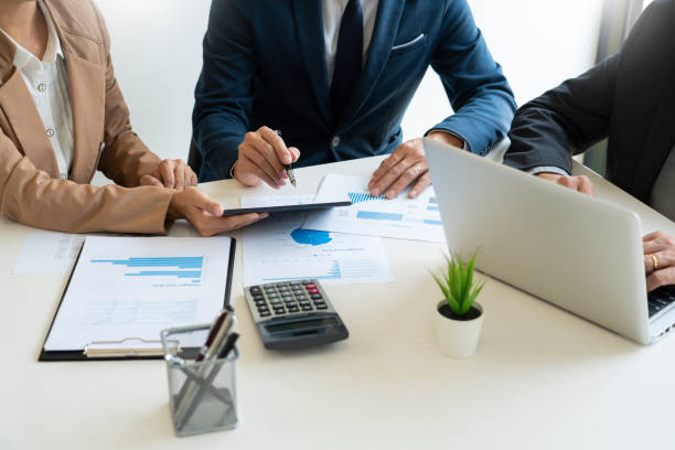 istock Business People Talking Discussing with coworker planning analyzing financial document data charts and graphs in Meeting and  successful teamwork Concept 1215881504