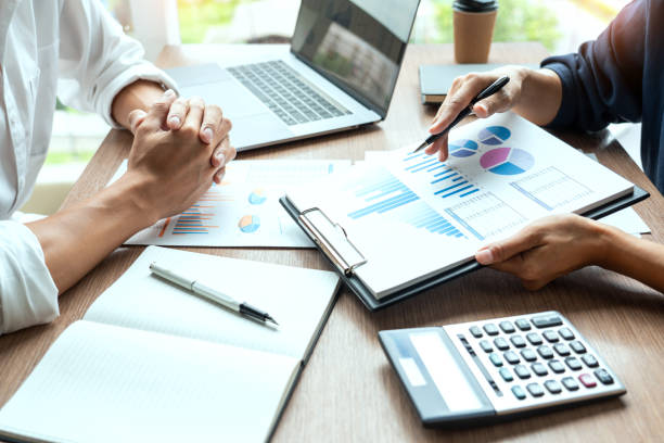 istock businessman discuss explaining new trends information on a document with colleague co-worker or partner together in a modern business office 1215881641