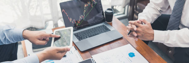 istock Working business man, team of broker or traders talking about forex on multiple computer screens of stock market invest trading financial graph charts data analysis. 1215884748
