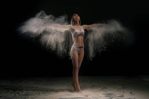 istock Young woman in white dust cloud shot 1215885250