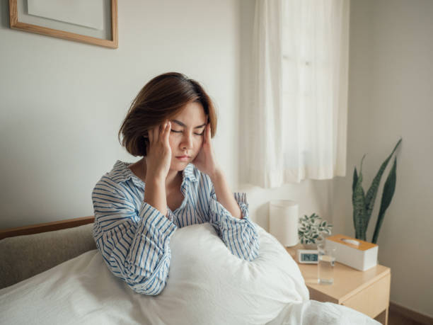 istock Young asian woman feeling sick at home. 1215885400