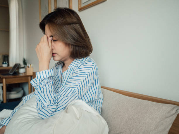 istock Young asian woman feeling sick at home. 1215885491