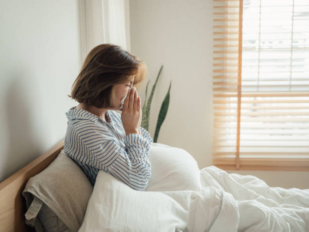 istock Woman Lying In Bed Suffering With Cold 1215885628