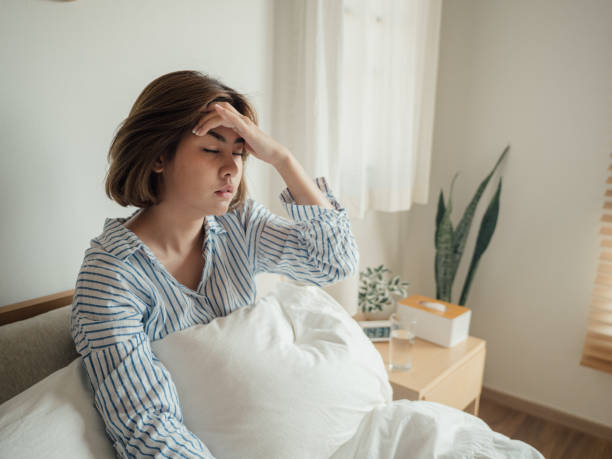 istock Young asian woman feeling sick at home. 1215885678