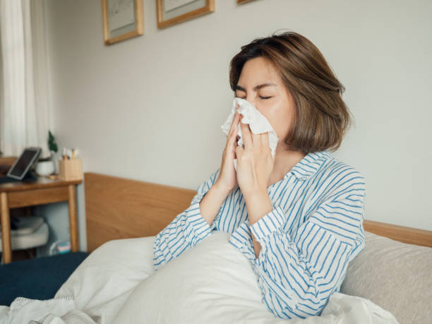 istock Asian woman awakening and sneezing 1215885681