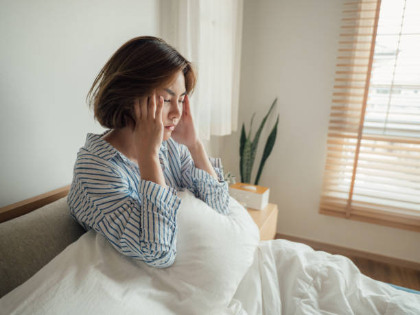 mujer asiática contrajo gripe y agua potable en la cama en casa. - problemas del sueño fotografías e imágenes de stock