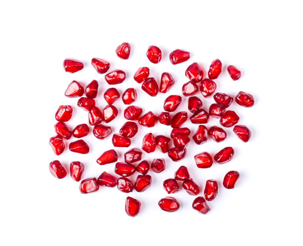 istock Pomegranate seeds isolated on white background. top view 1215885944
