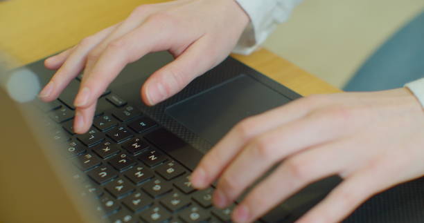 istock Hands typing on computer keyboard, moving camera, business woman working on laptop pc in office. 1215890525