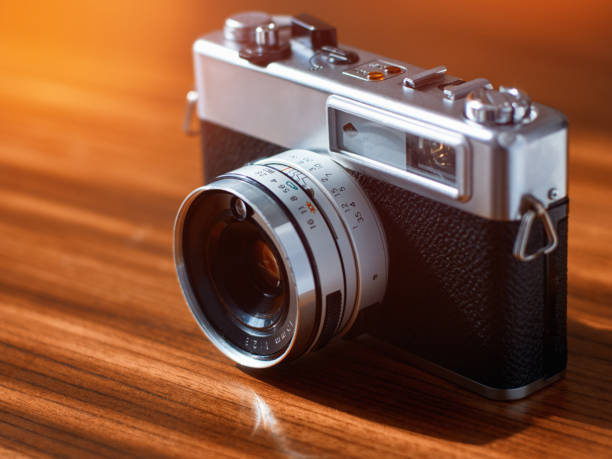 istock Rangefinder film camera on a wooden table 1215892014