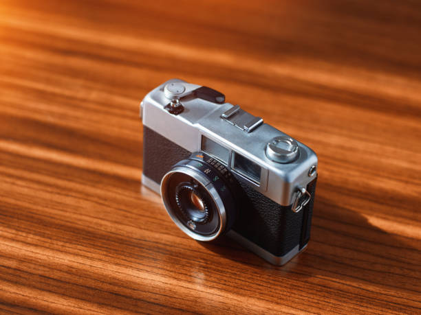 istock Rangefinder film camera on a wooden table 1215892074