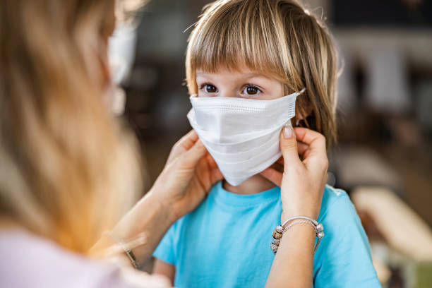 istock Small boy with protective mask during corona virus at home. 1215892379