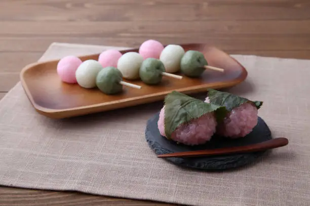sakura mochi and dango 3 colored dumpling rice cake on plate isolated on table cloth